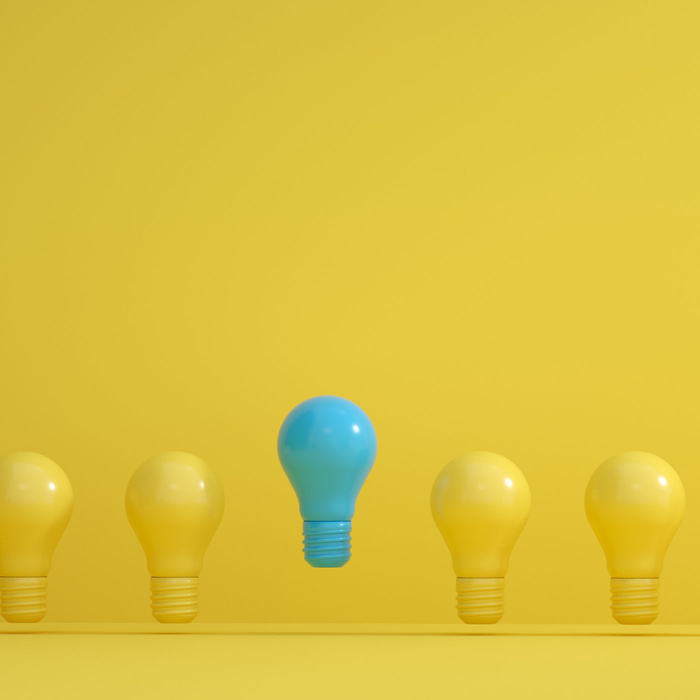 A row of five light bulbs on a bright yellow background, with four yellow bulbs evenly spaced and a single blue bulb floating slightly above them in the center.