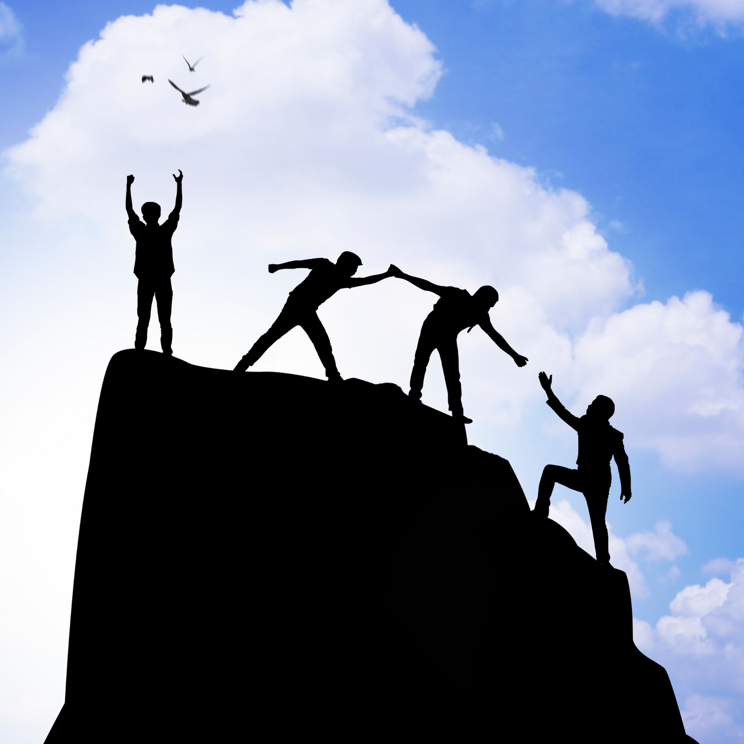 Silhouettes of four people on a mountain peak, with one person celebrating, two helping each other, and one climbing up, symbolizing teamwork and achievement.